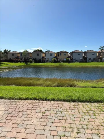 a view of a lake with houses in the back