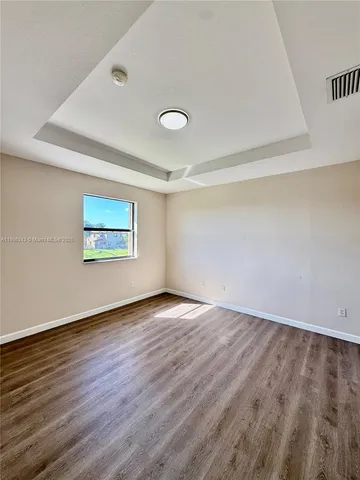a spacious bathroom with a tub sink and mirror