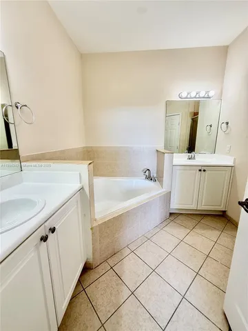 a bathroom with a shower sink and mirror