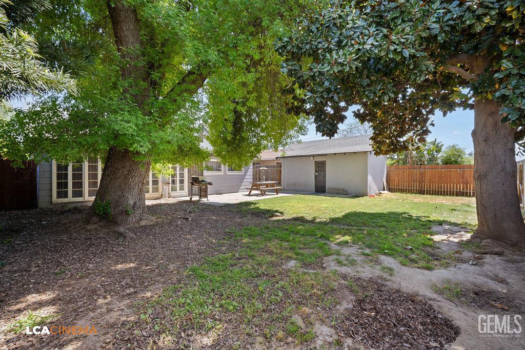 Undisclosed Address Shafter, CA 93263 - Photo 20 of 21 a front view of a house with a yard and a garage