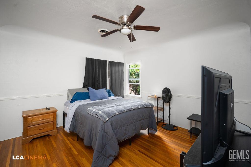 Undisclosed Address Shafter, CA 93263 - Photo 7 of 21 a bedroom with a bed and wooden floor
