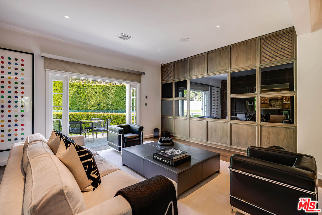 9551 Lime Orchard Road Beverly Hills, CA 90210 - Photo 13 of 27 a living room with furniture and large windows
