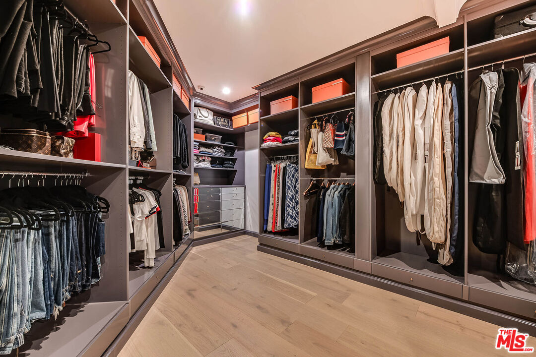 9551 Lime Orchard Road Beverly Hills, CA 90210 - Photo 22 of 27 a view of walk in closet with clothes and shoes
