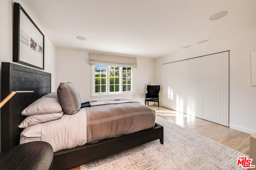 9551 Lime Orchard Road Beverly Hills, CA 90210 - Photo 23 of 27 a bedroom with a bed couch and a window