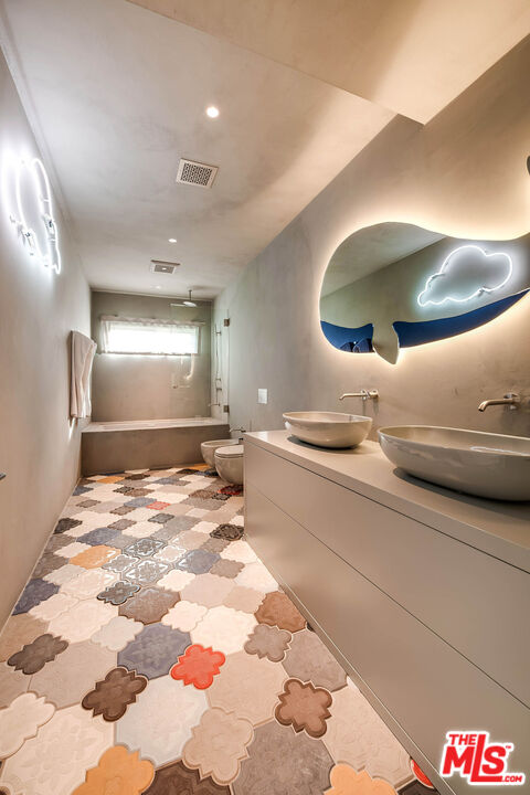 9551 Lime Orchard Road Beverly Hills, CA 90210 - Photo 24 of 27 a bathroom with a sink a toilet and mirror