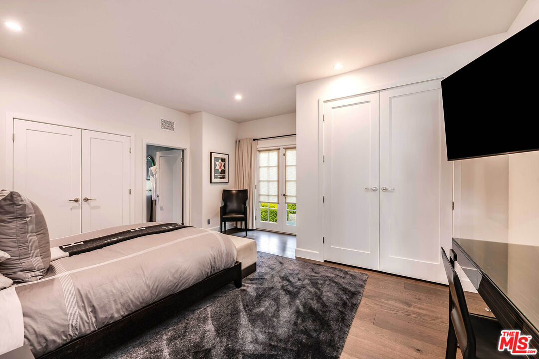 9551 Lime Orchard Road Beverly Hills, CA 90210 - Photo 25 of 27 a bedroom with a bed and a flat screen tv