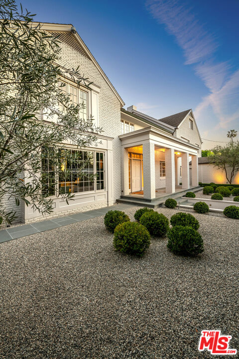 9551 Lime Orchard Road Beverly Hills, CA 90210 - Photo 3 of 27 a front view of a house with garden