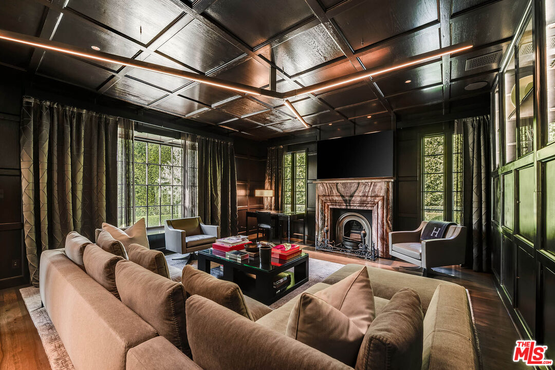 9551 Lime Orchard Road Beverly Hills, CA 90210 - Photo 5 of 27 a view of a livingroom with furniture a fireplace and windows