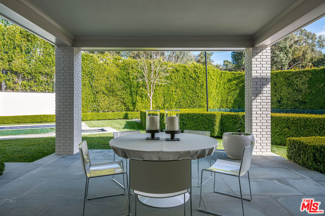 9551 Lime Orchard Road Beverly Hills, CA 90210 - Photo 7 of 27 a view of a patio with a table chairs and a backyard