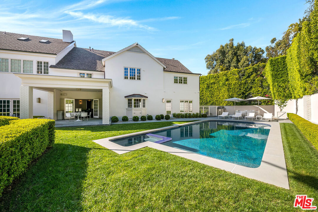 9551 Lime Orchard Road Beverly Hills, CA 90210 - Photo 8 of 27 a view of a house with pool and a yard