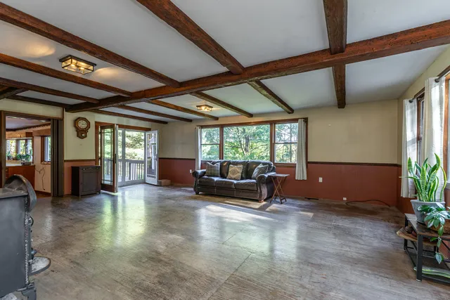 a living room with furniture window and wooden floor