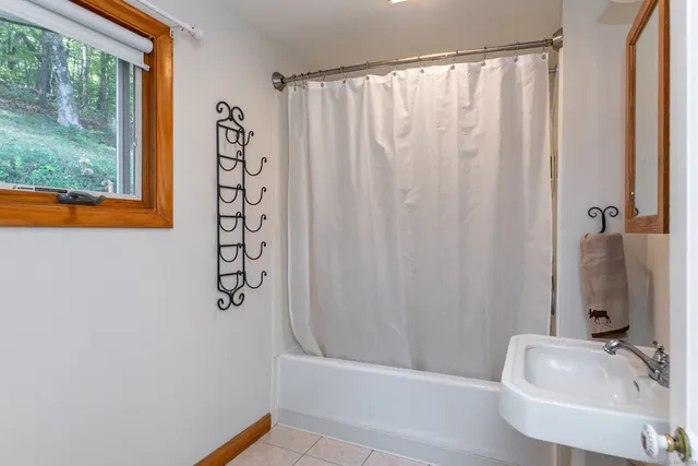 a bathroom with a sink a bathtub and shower