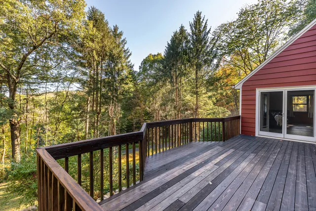 a view of balcony with wooden floor and fence