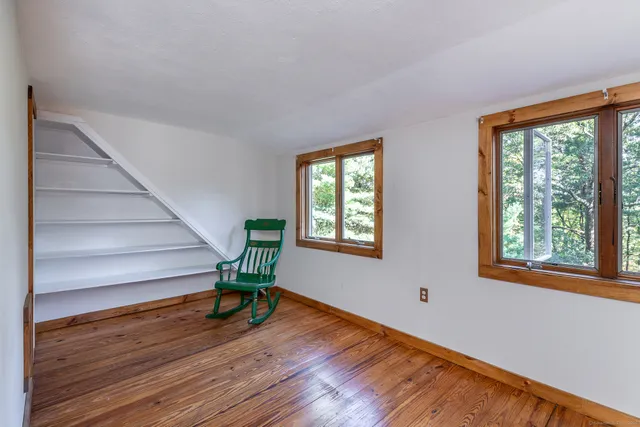 a view of a livingroom with furniture wooden floor and a window