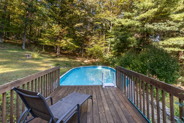 a balcony with wooden floor and fence