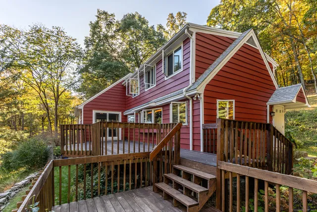 a balcony with wooden floor and fence