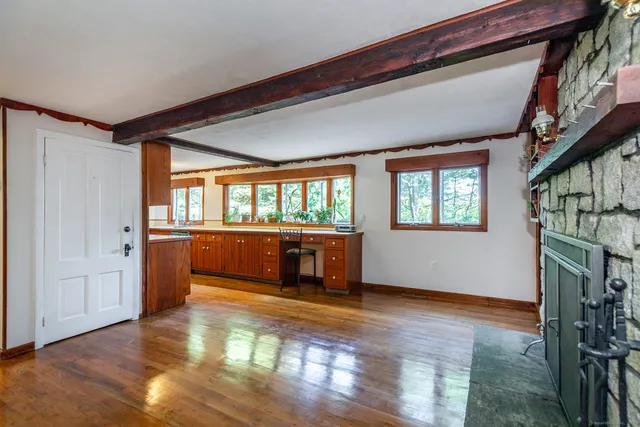 wooden floor in an empty room with a window