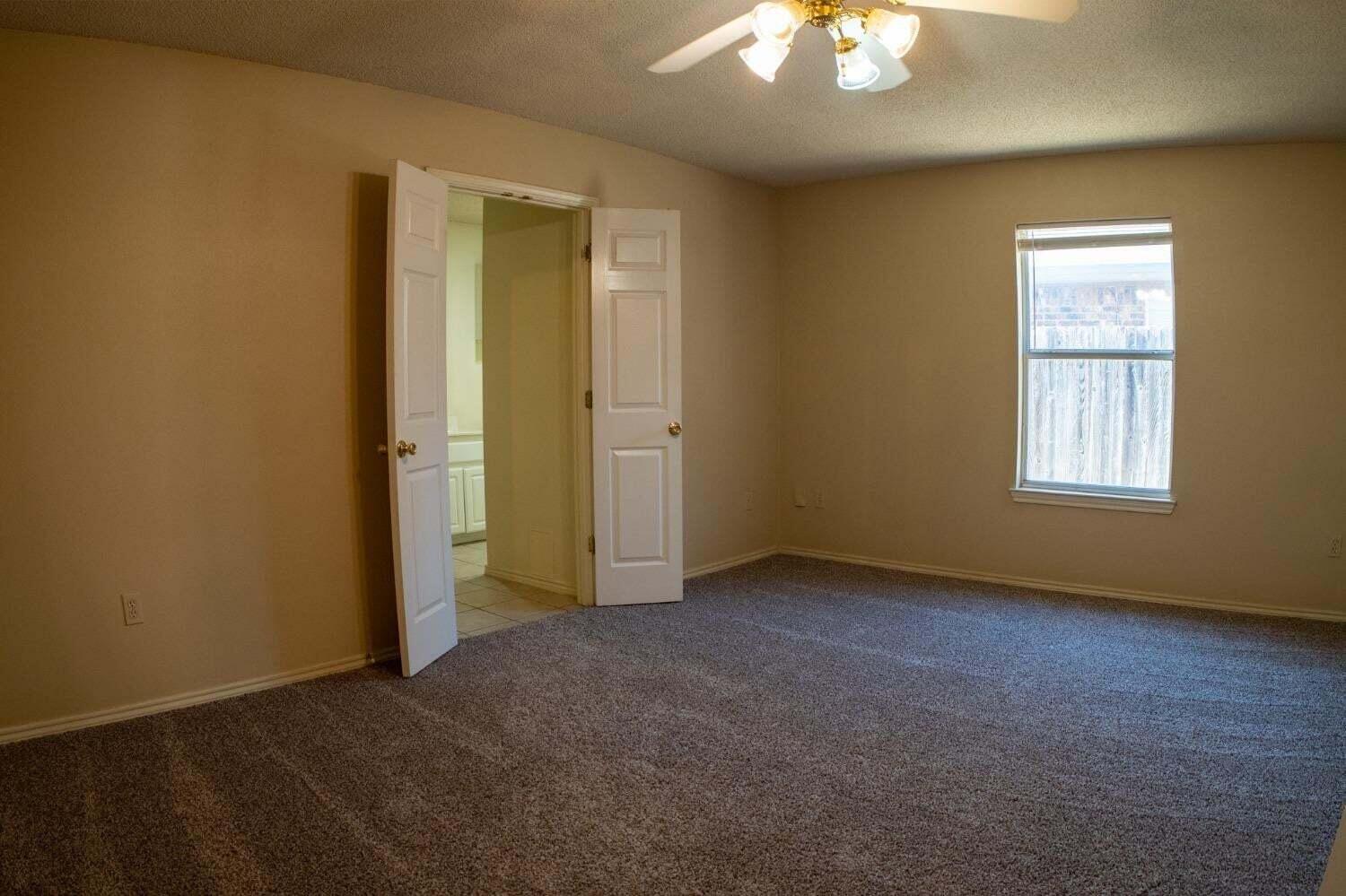 3410 97th Street Lubbock, TX 79423 - Photo 9 of 21 an empty room with windows and closet