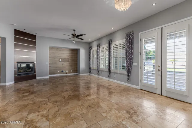 a view of a kitchen with a sink and a chandelier fan