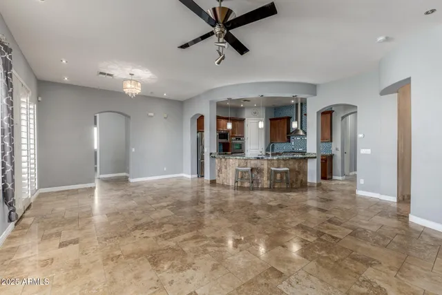 a kitchen with kitchen island a dining table and chairs