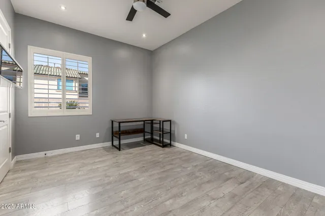 an entryway with wooden floor and cabinet