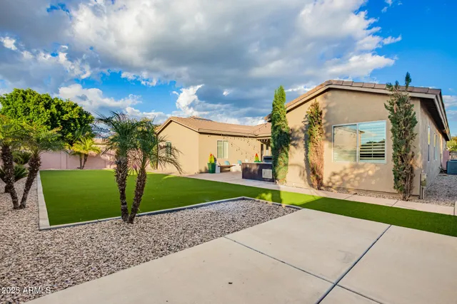 a view of a house with a backyard