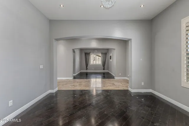 a view of a livingroom with wooden floor and a window