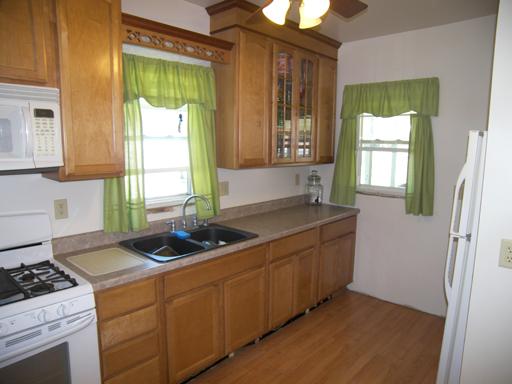 860 Walnut Road LaSalle, IL 61301 - Photo 3 of 8 a kitchen with a stove a refrigerator and a window