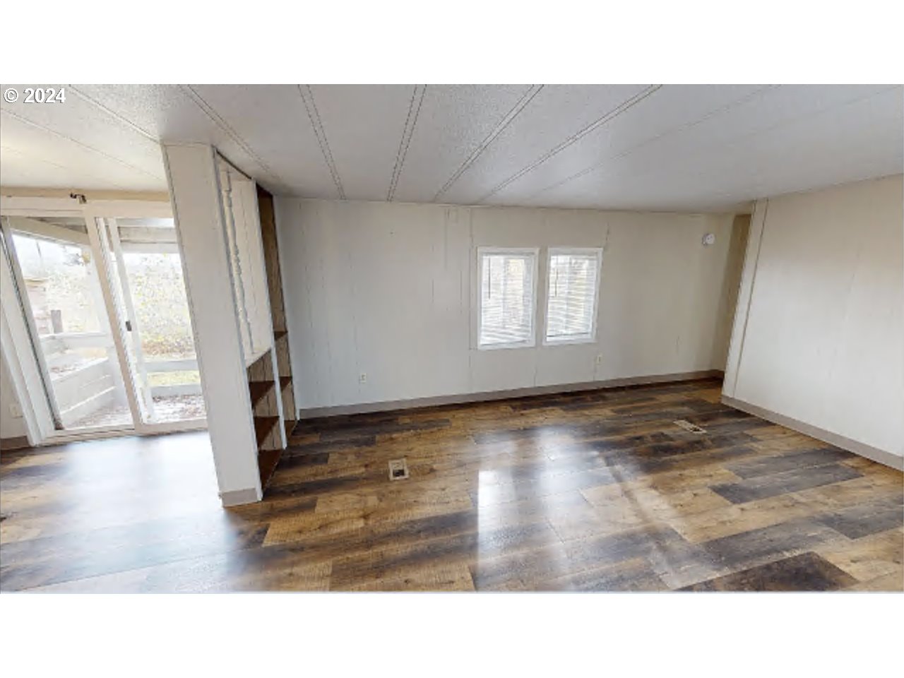 80978 Division Road Irrigon, OR 97844 - Photo 6 of 7 a open hall with wooden floor and a floor to ceiling window