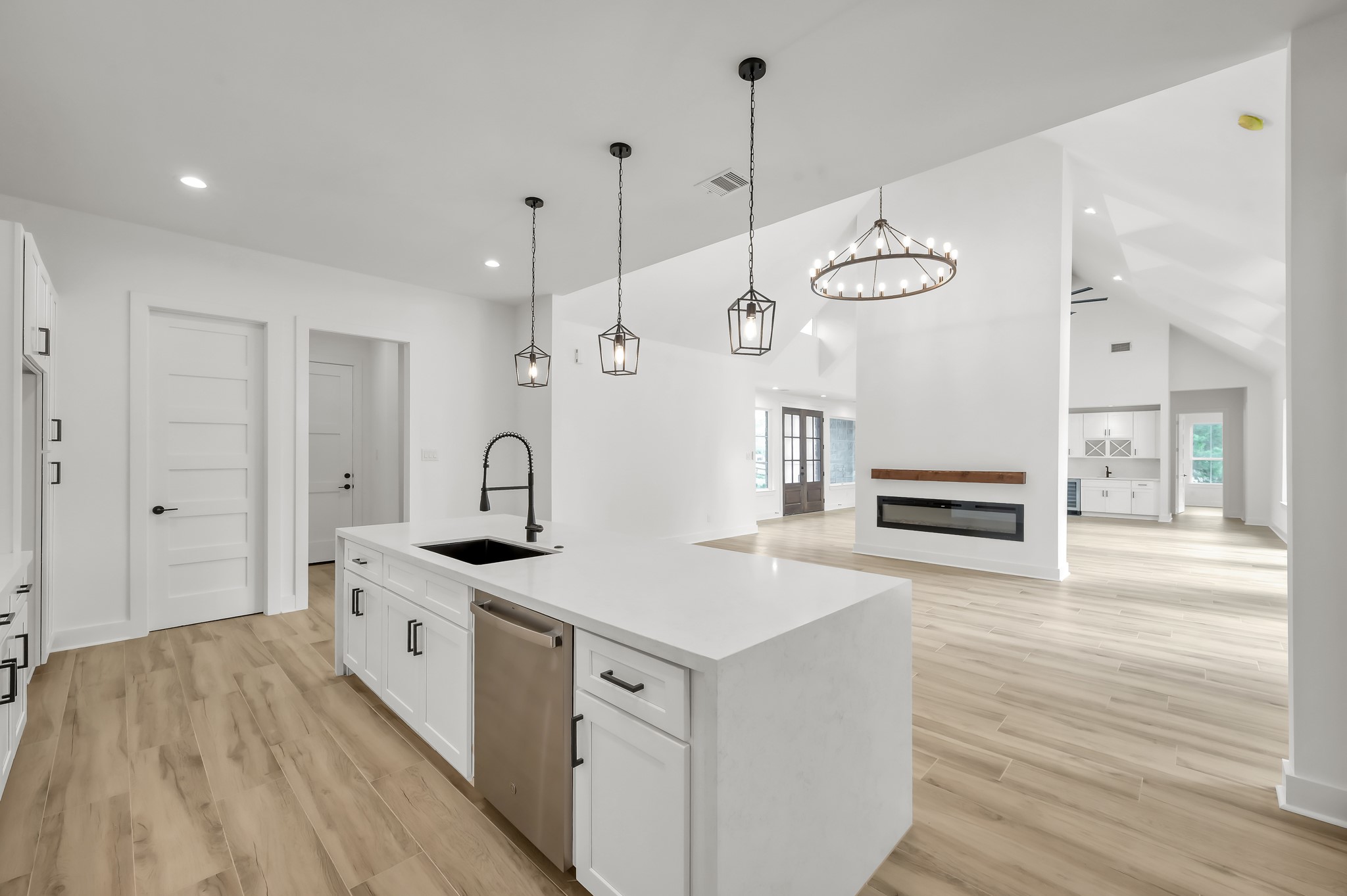 14742 Turquoise Trail Willis, TX 77378 - Photo 19 of 48 The oversized island with farmhouse-style sink and dishwasher provides both functionality and style while maintaining views into the living space.