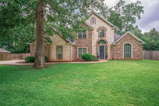 a front view of house with yard and green space
