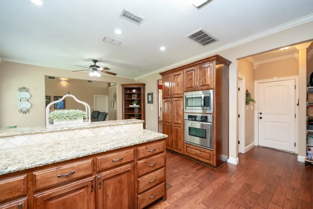 a view of kitchen with granite countertop cabinets and wooden floor