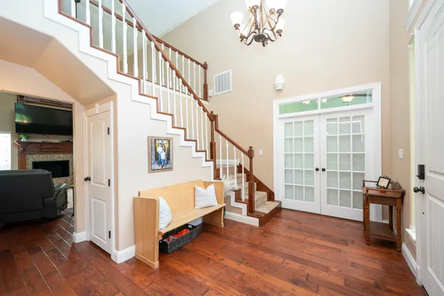 a view of an entryway with wooden floor and livingroom