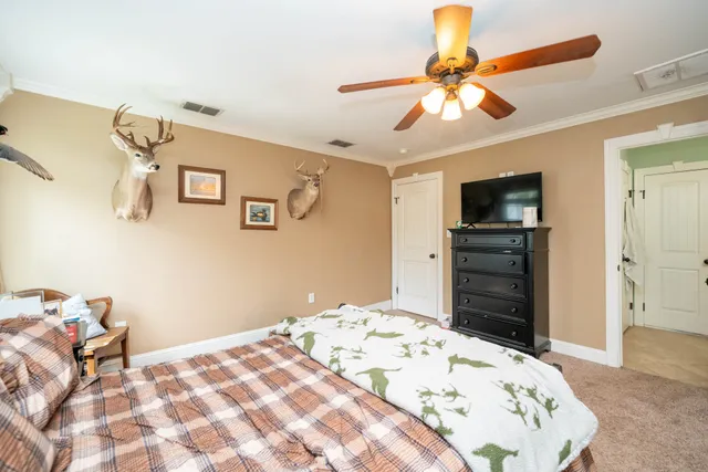 a bedroom with a bed and a television