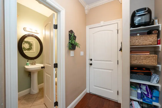 a view of a hallway with wooden floor and closet