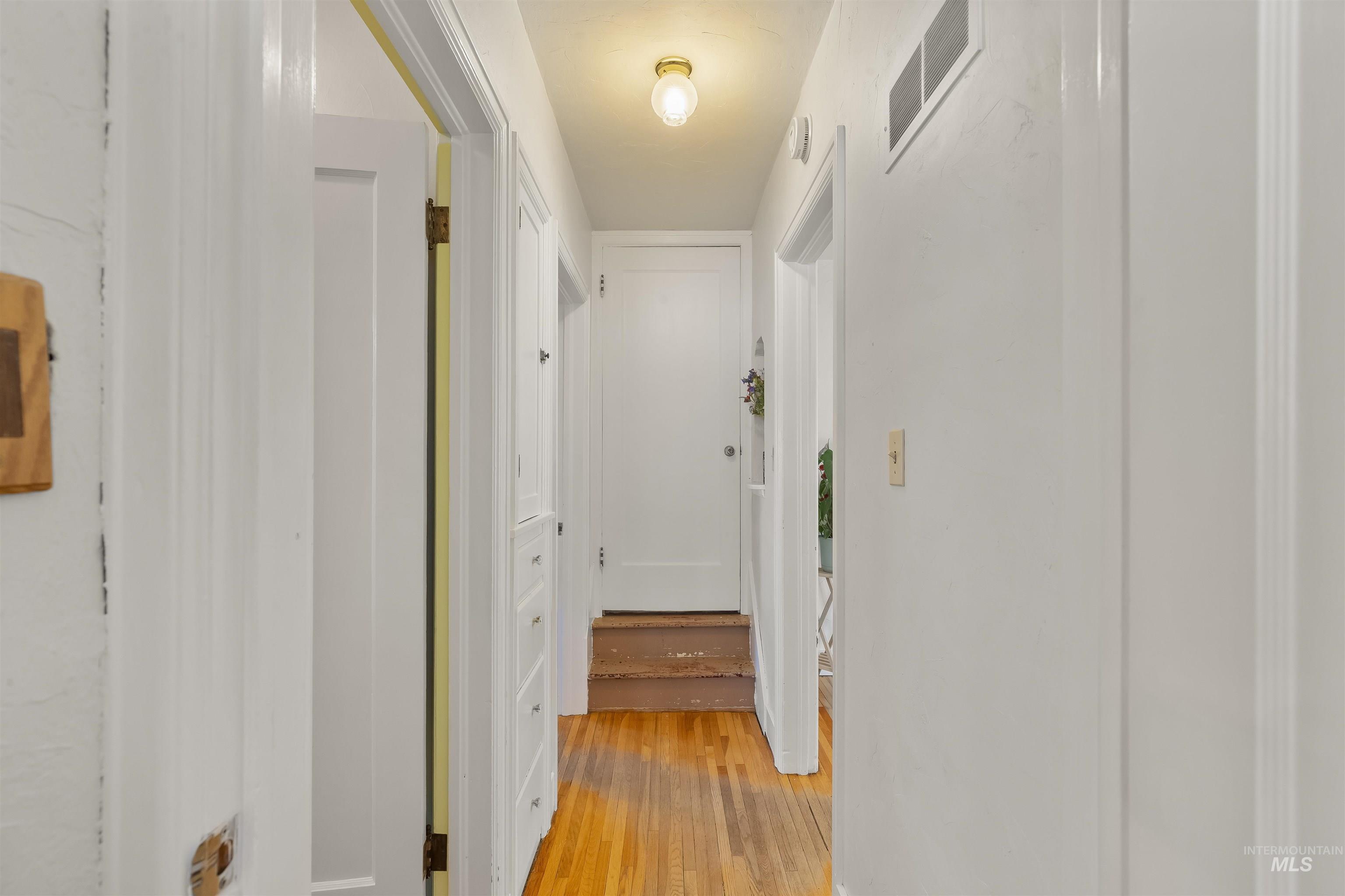 924 N Street Lewiston, ID 83501 - Photo 18 of 46 Hallway featuring wood-finish flooring and multiple white doors
