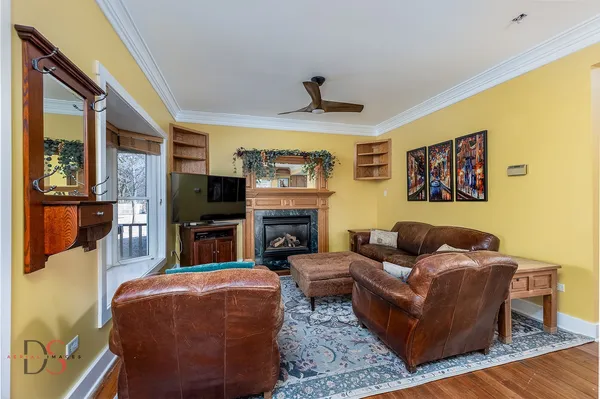 a living room with furniture a flat screen tv and a fireplace