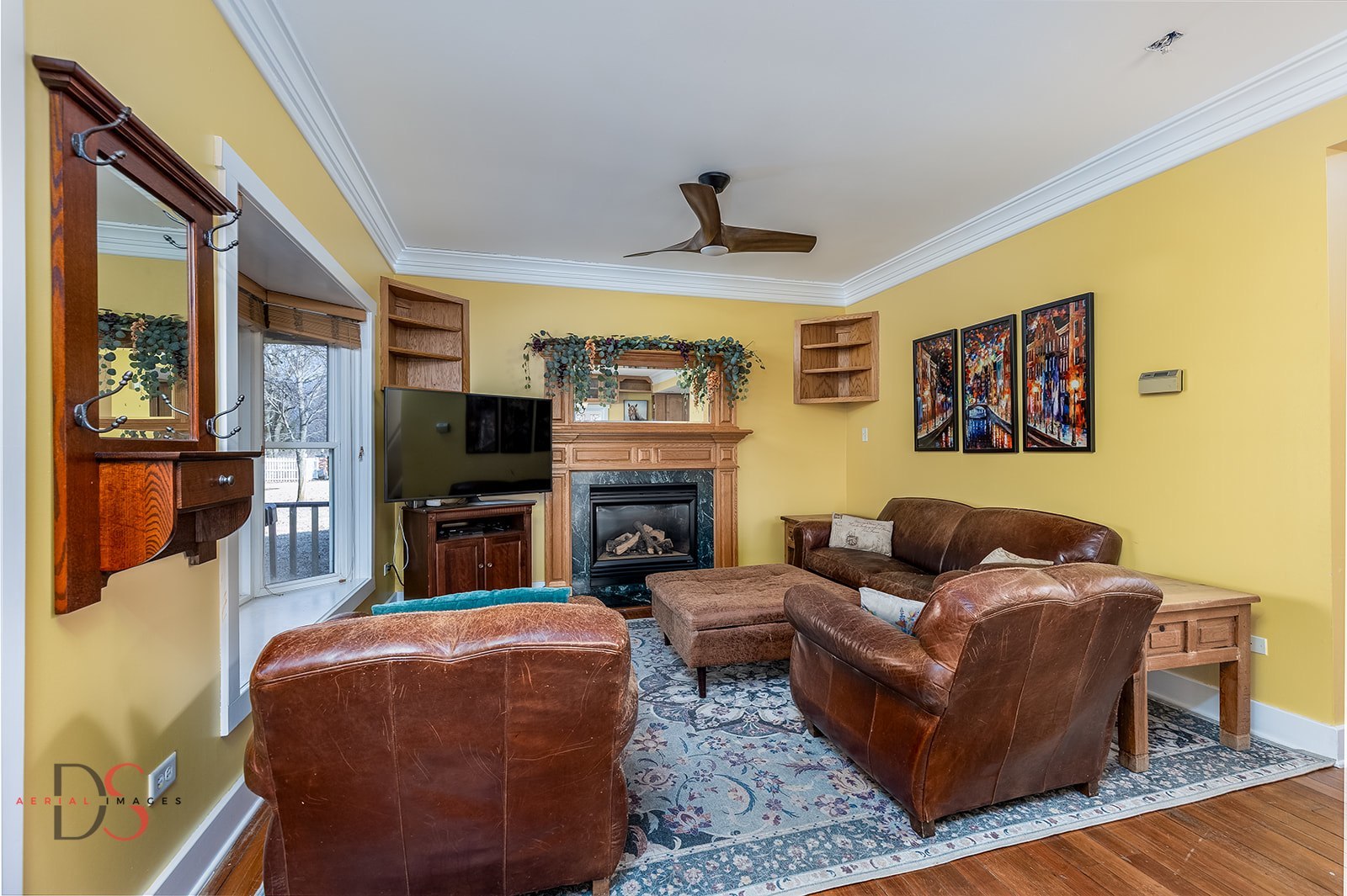 10978 A Crimmin Road Newark, IL 60541 - Photo 9 of 24 a living room with furniture a flat screen tv and a fireplace