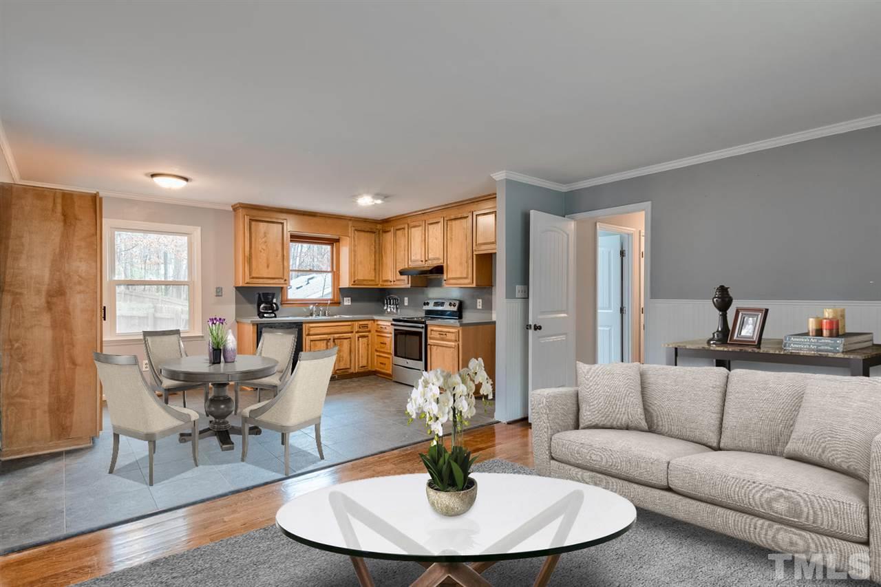 7300 Post Oak Road Raleigh, NC 27615 - Photo 2 of 30 a living room with furniture and a dining table with kitchen view