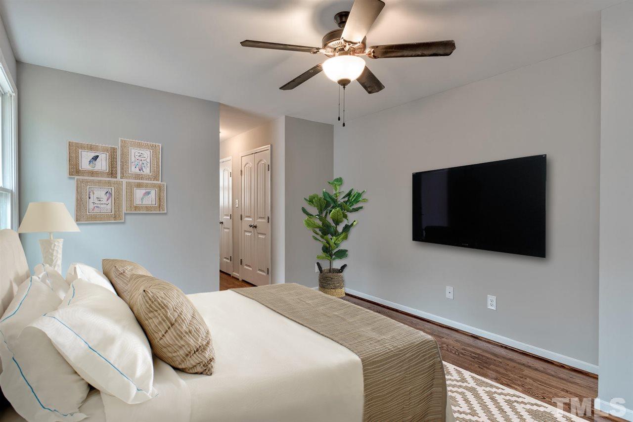 7300 Post Oak Road Raleigh, NC 27615 - Photo 11 of 30 a bedroom with a bed and a flat screen tv