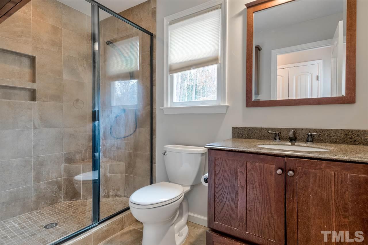 7300 Post Oak Road Raleigh, NC 27615 - Photo 12 of 30 a bathroom with a granite countertop sink toilet and shower