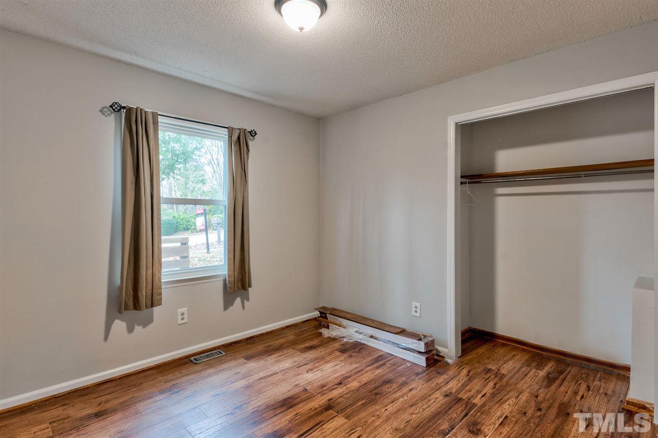7300 Post Oak Road Raleigh, NC 27615 - Photo 15 of 30 a view of an empty room with wooden floor and a window