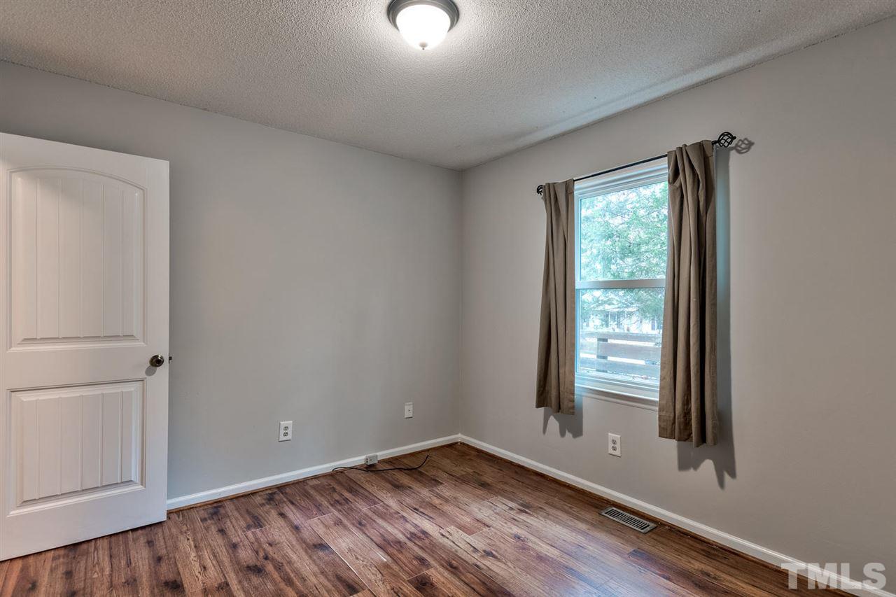 7300 Post Oak Road Raleigh, NC 27615 - Photo 16 of 30 a view of an empty room with wooden floor and a window