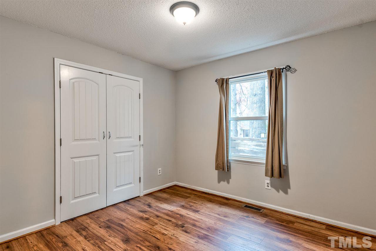 7300 Post Oak Road Raleigh, NC 27615 - Photo 17 of 30 an empty room with wooden floor and windows