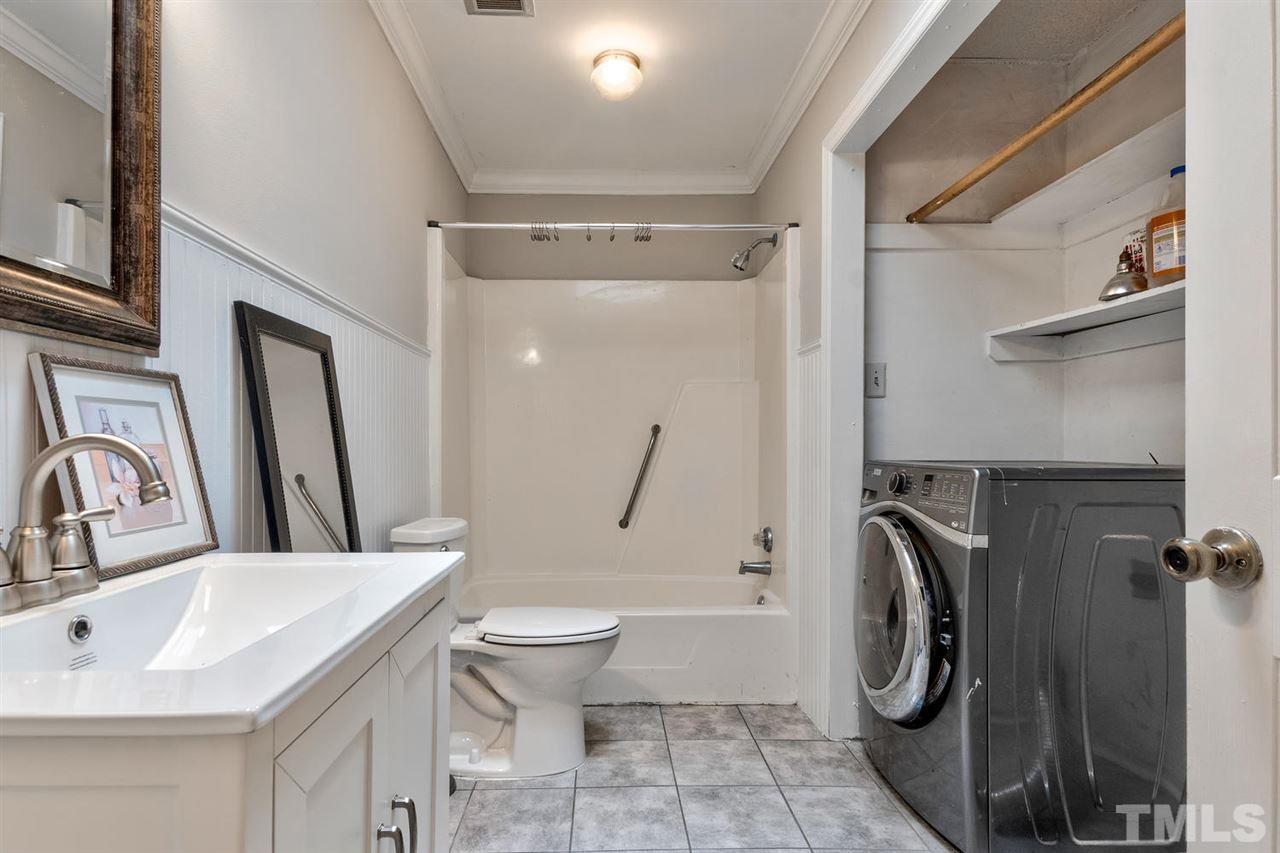 7300 Post Oak Road Raleigh, NC 27615 - Photo 19 of 30 a bathroom with a sink toilet and shower