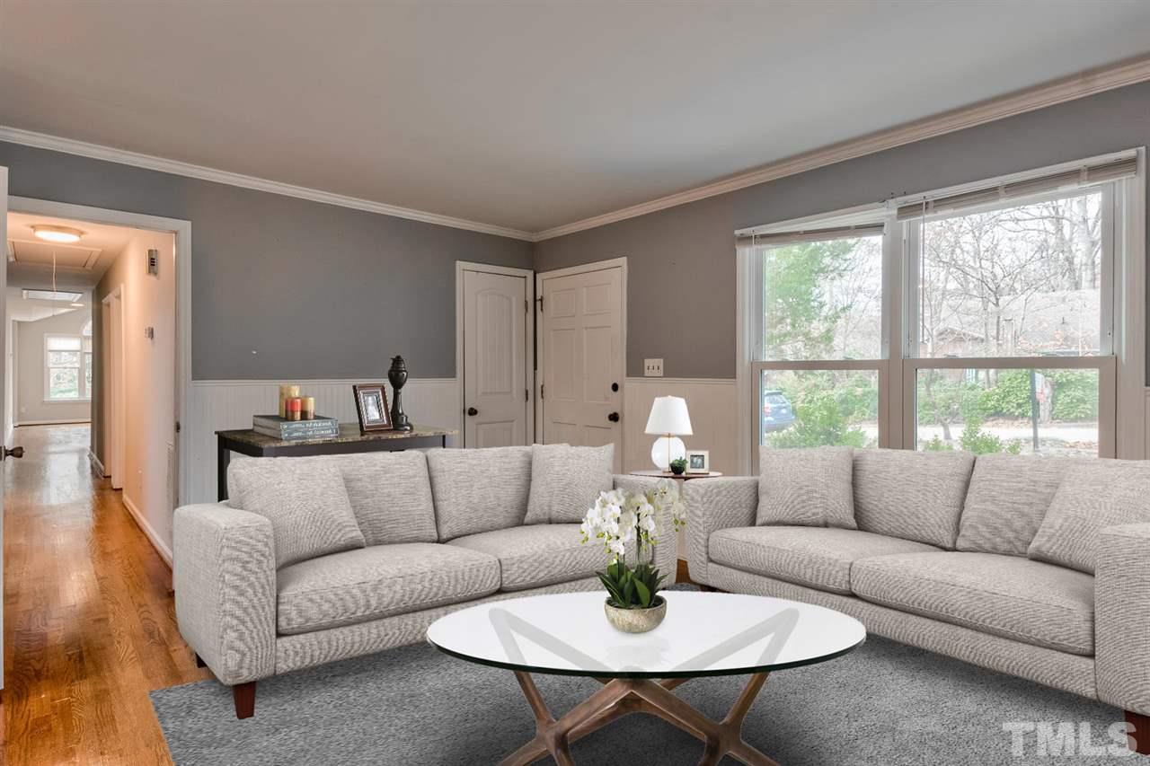 7300 Post Oak Road Raleigh, NC 27615 - Photo 3 of 30 a living room with furniture and a table