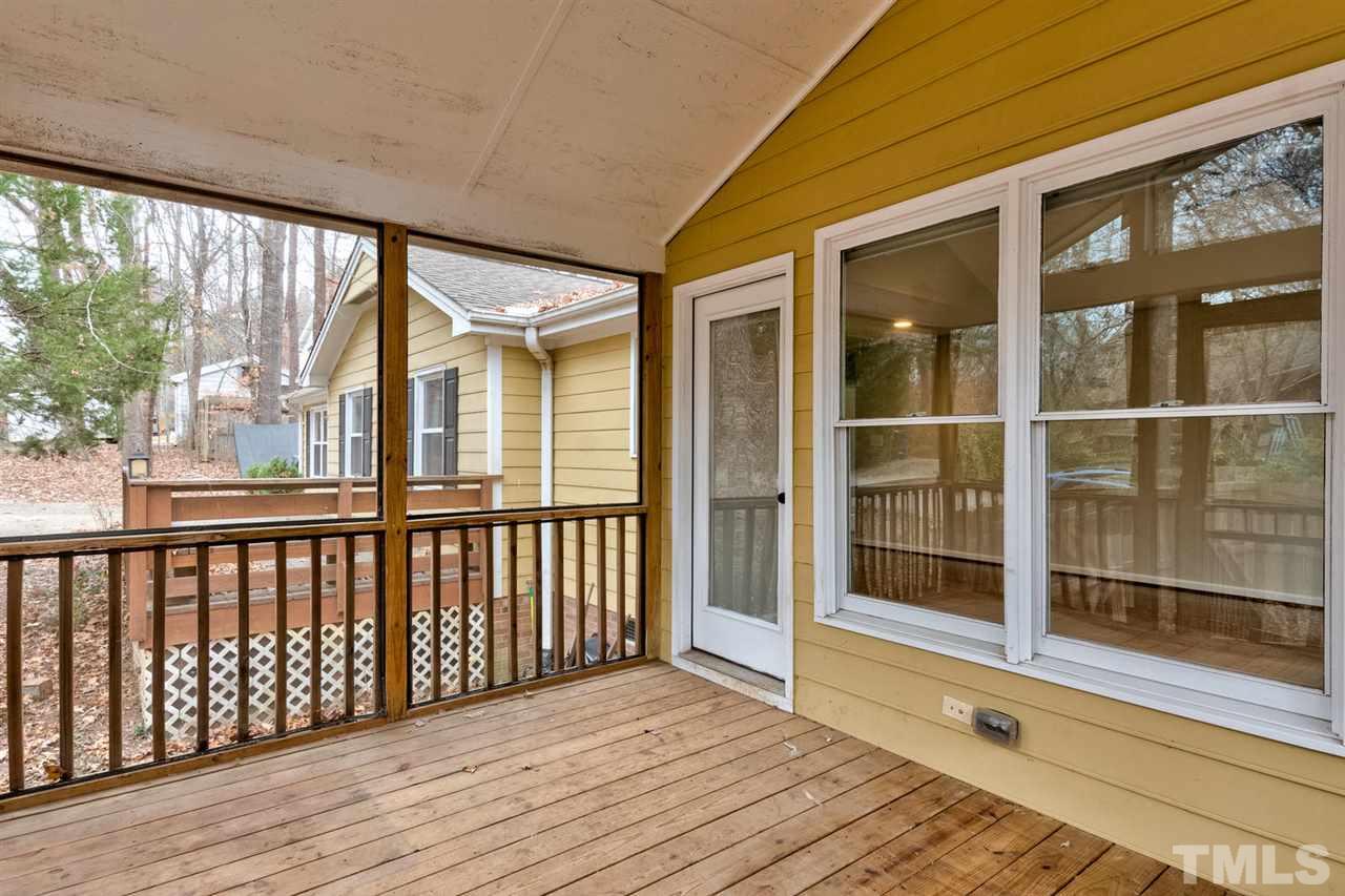 7300 Post Oak Road Raleigh, NC 27615 - Photo 23 of 30 a view of a balcony with wooden floor and iron stairs