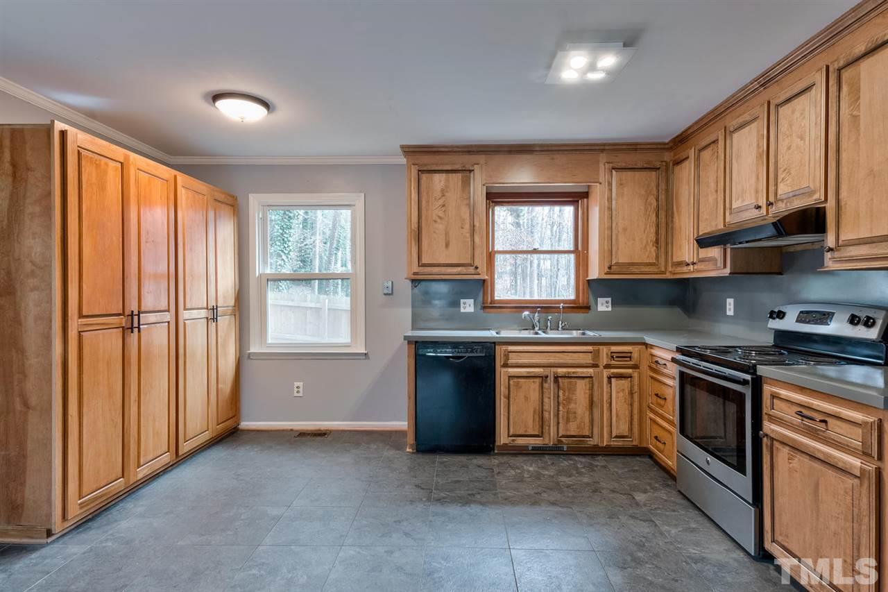 7300 Post Oak Road Raleigh, NC 27615 - Photo 4 of 30 a kitchen with stainless steel appliances granite countertop a stove top oven sink and cabinets