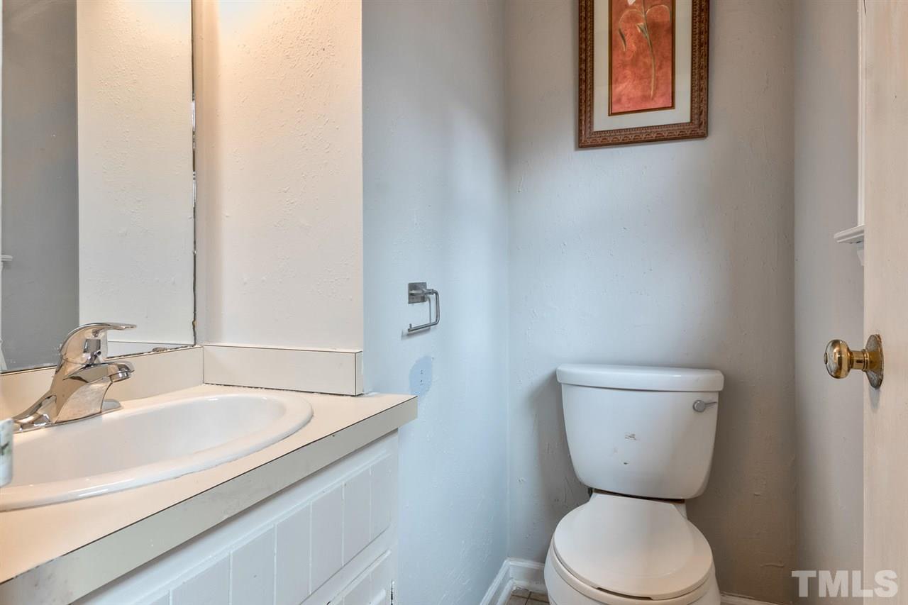 7300 Post Oak Road Raleigh, NC 27615 - Photo 9 of 30 a bathroom with a toilet sink and mirror