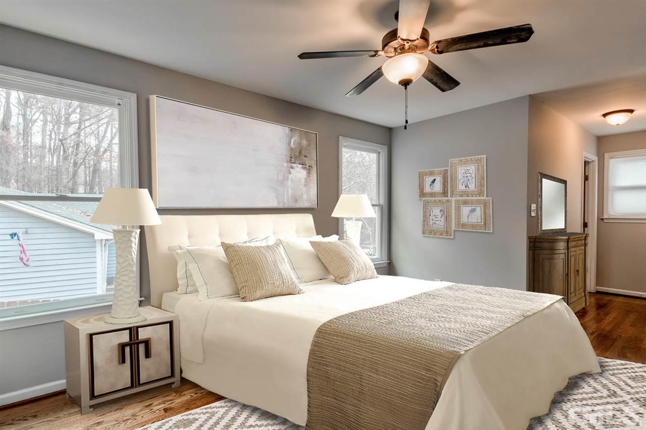 7300 Post Oak Road Raleigh, NC 27615 - Photo 10 of 30 a bedroom with a bed and a chandelier